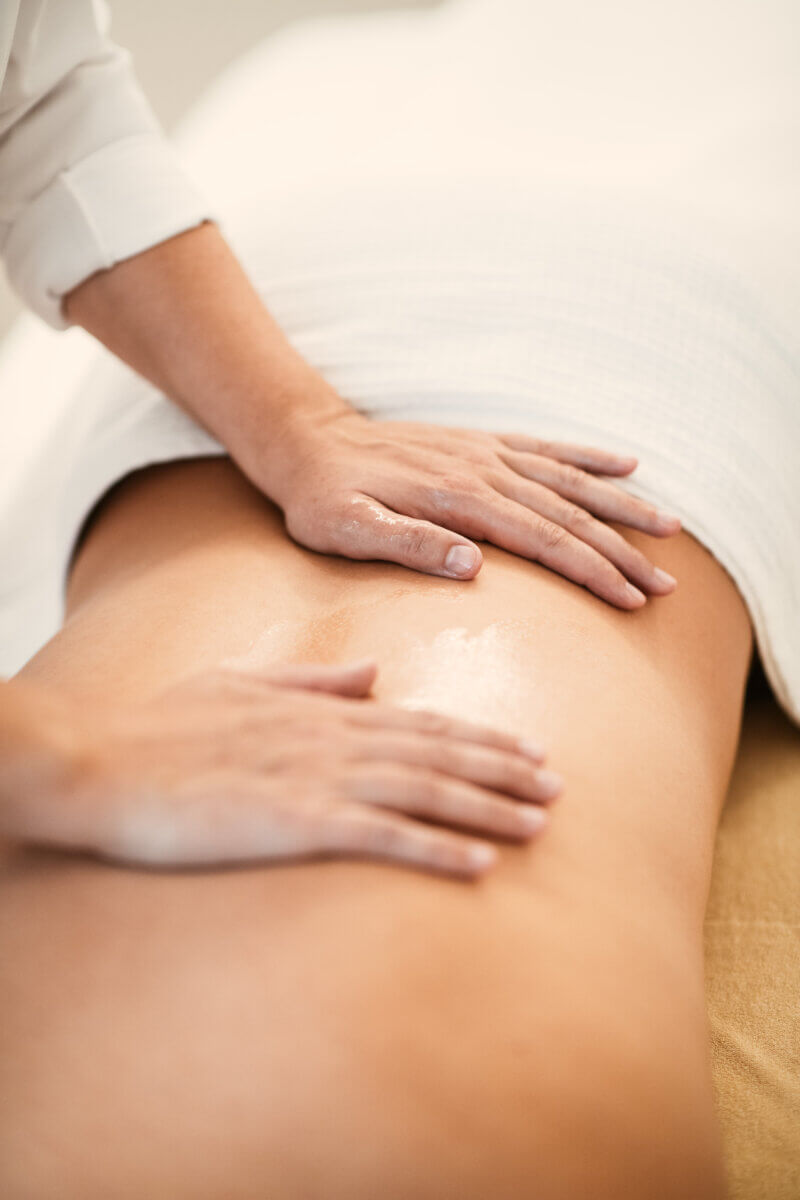 Sanfte Massagegriffe am Rücken während einer ARMT-Behandlung